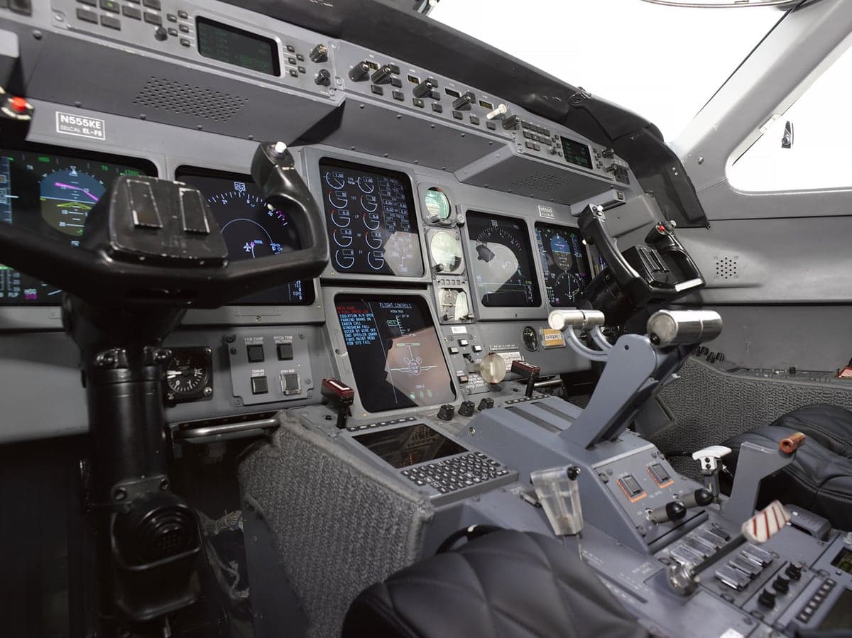 A detailed view of the Gulfstream G650 cockpit, showing the instrument panel, yokes, and center console.