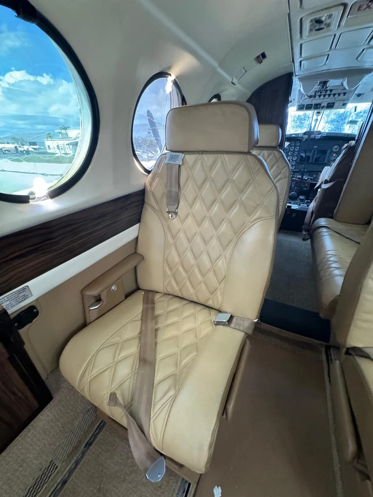 Interior view of the King Air 200 cabin with tan leather seats.