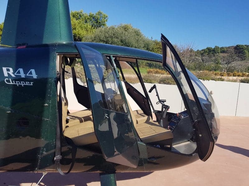 Interior view of the Robinson R44 Clipper helicopter, showing the seats and cockpit.