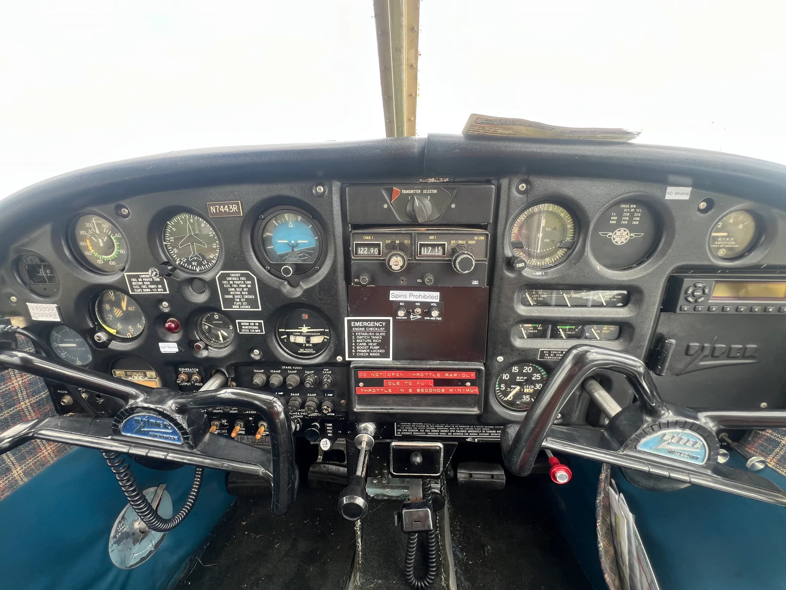 Wide view of the cockpit instrument panel with yokes and various gauges.