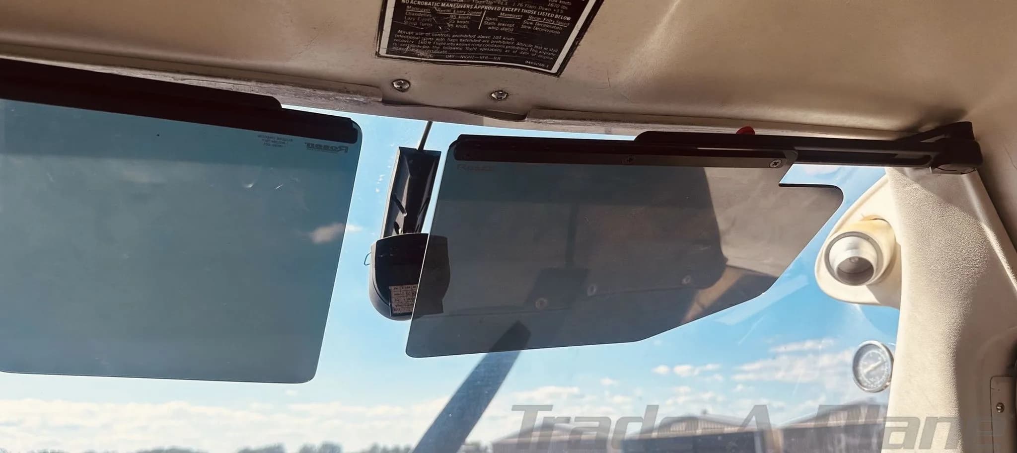 Interior view of the Cessna 152 windshield with sun visors deployed.
