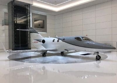 A HondaJet on display in a showroom setting.