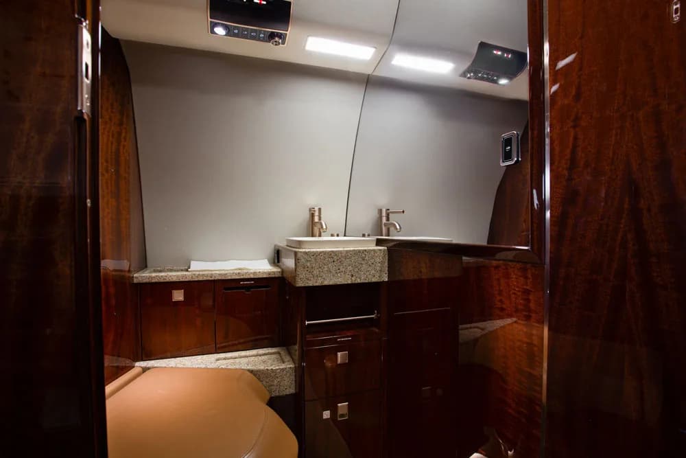 Aircraft lavatory with sink and vanity.