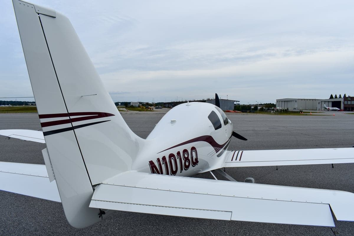 Side view of a white Cessna Corvalis with tail number N1018Q on the tarmac.
