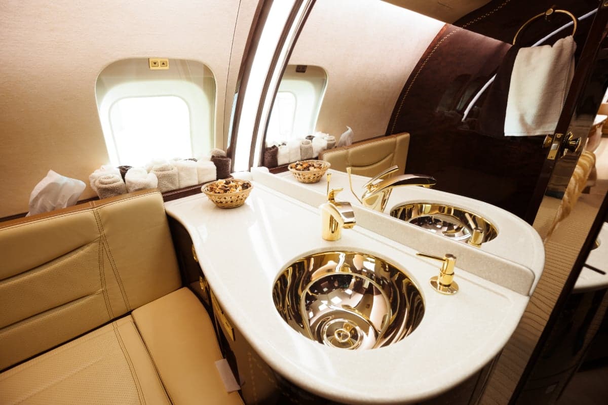 Close-up of the aircraft lavatory with gold fixtures.