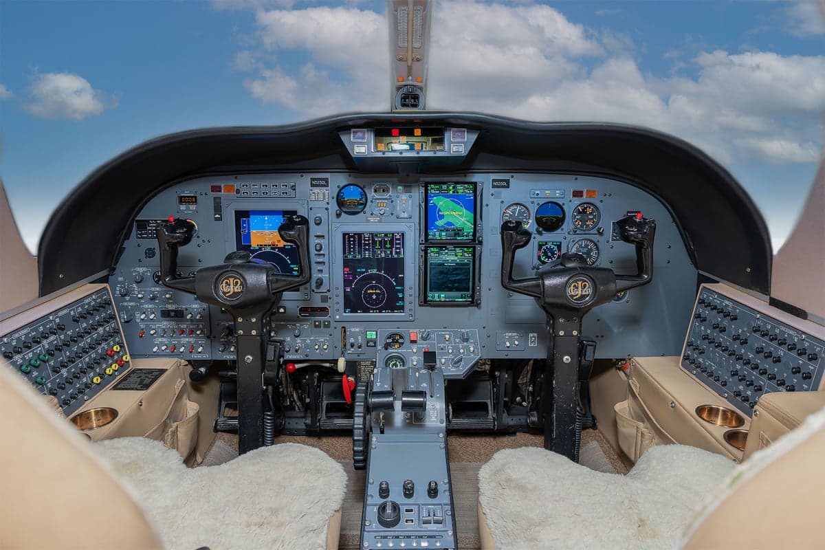 Full view of the aircraft cockpit with instrument panel and seats.
