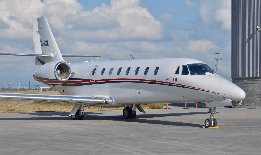 Side view of the XA-GIM aircraft on the tarmac.