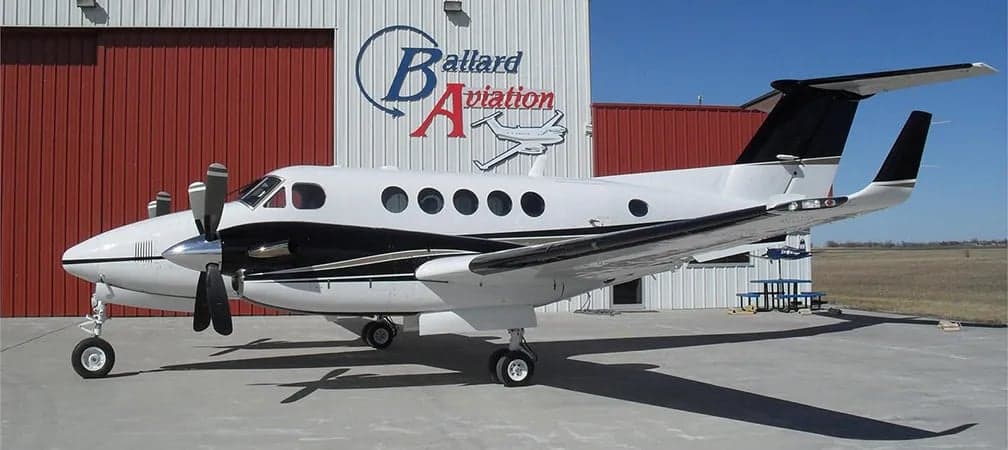 King Air aircraft parked in front of a hangar.