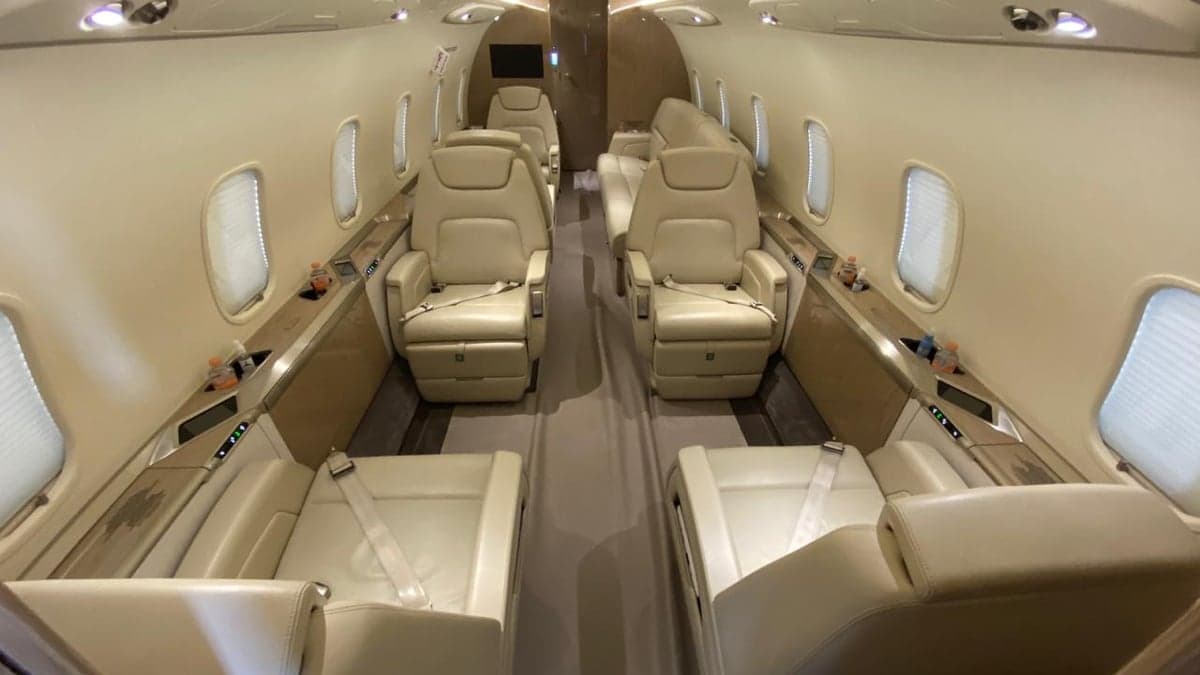 View of the aircraft cabin with cream-colored leather seats.