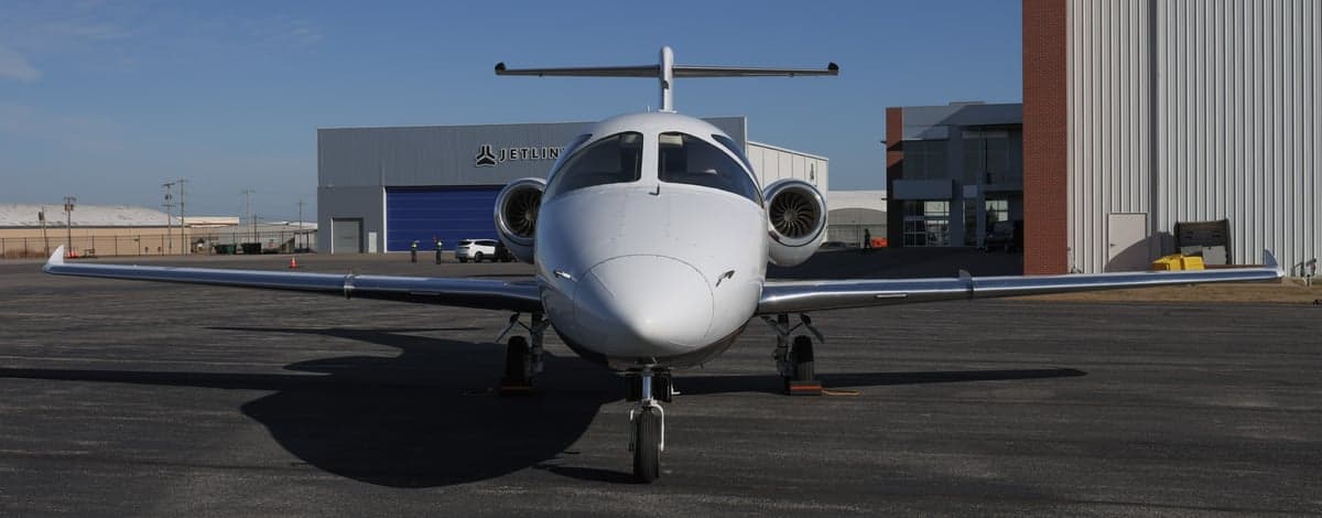 Front view of a Hawker 400XP aircraft on the tarmac.