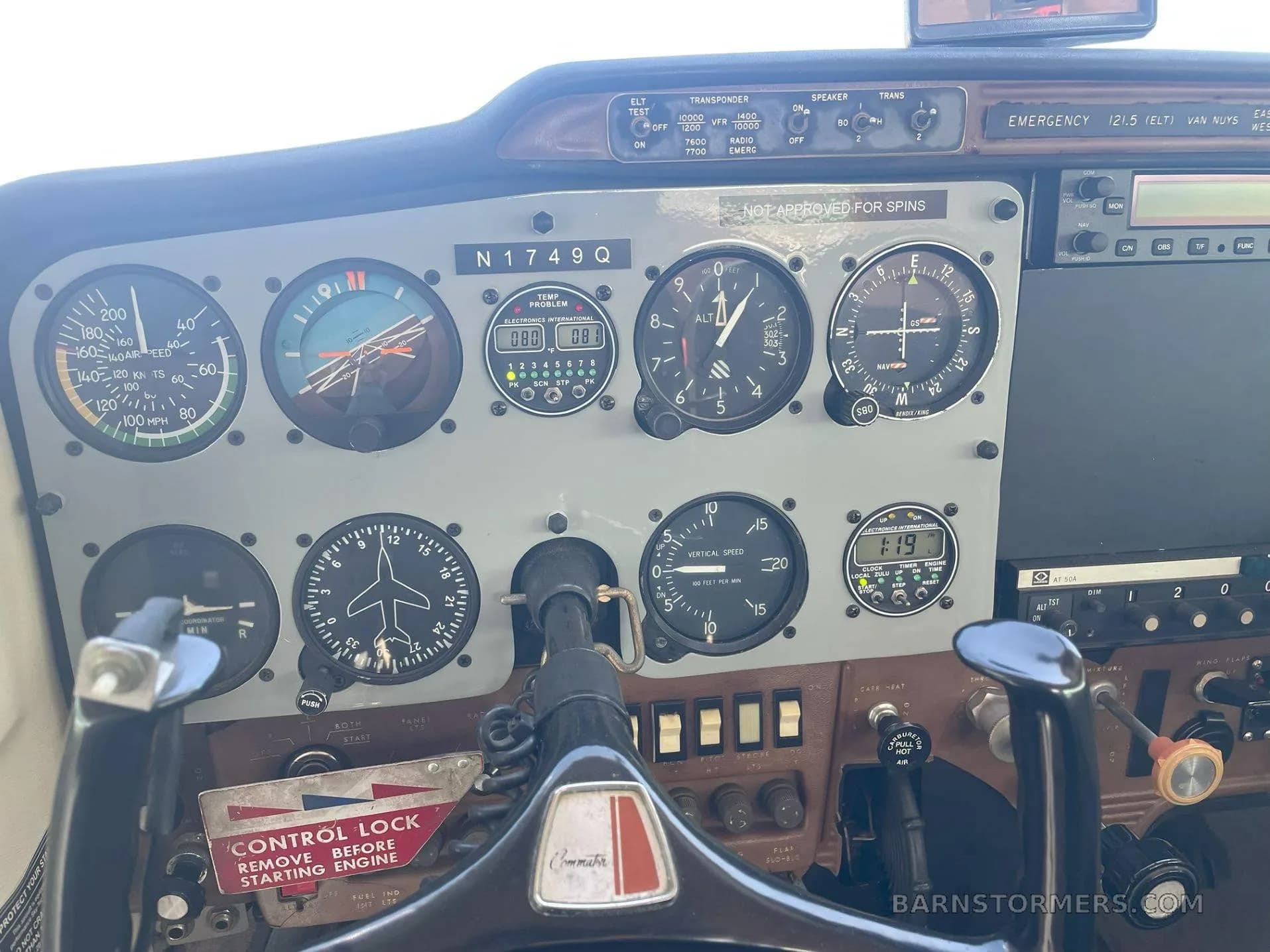 A close-up view of the instrument panel and control yoke in a Cessna 172 cockpit, showing various gauges and controls.
