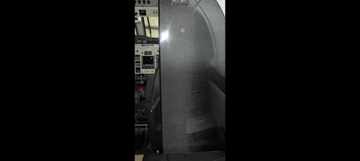 View of the aircraft interior with a carbon fiber panel.