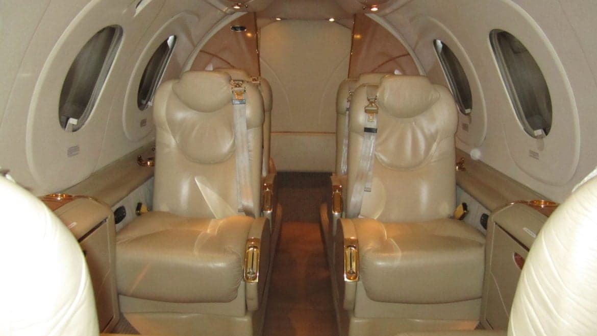 The interior of the aircraft cabin with leather seats.