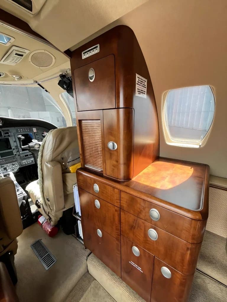 A view of the interior cabin of the aircraft, showing the cabinetry and cockpit.