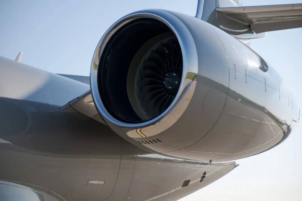 Close-up of the engine of a gray Gulfstream jet.