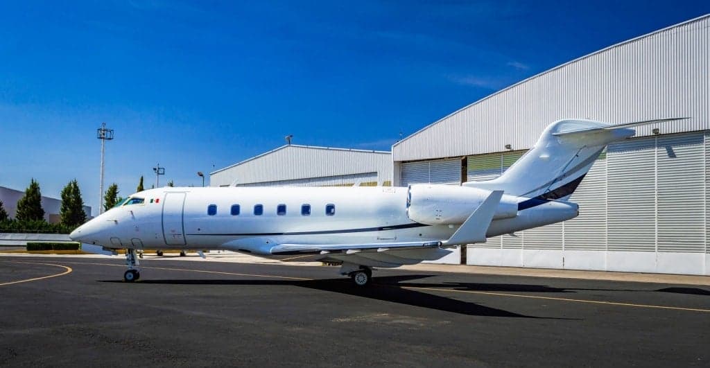 Side view of a Bombardier Challenger 300 parked on the tarmac.