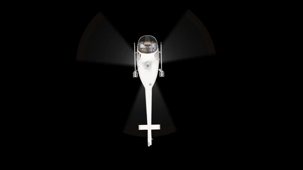 A top-down view of a white helicopter with orange-tipped rotor blades, showing its symmetrical design against a plain background.