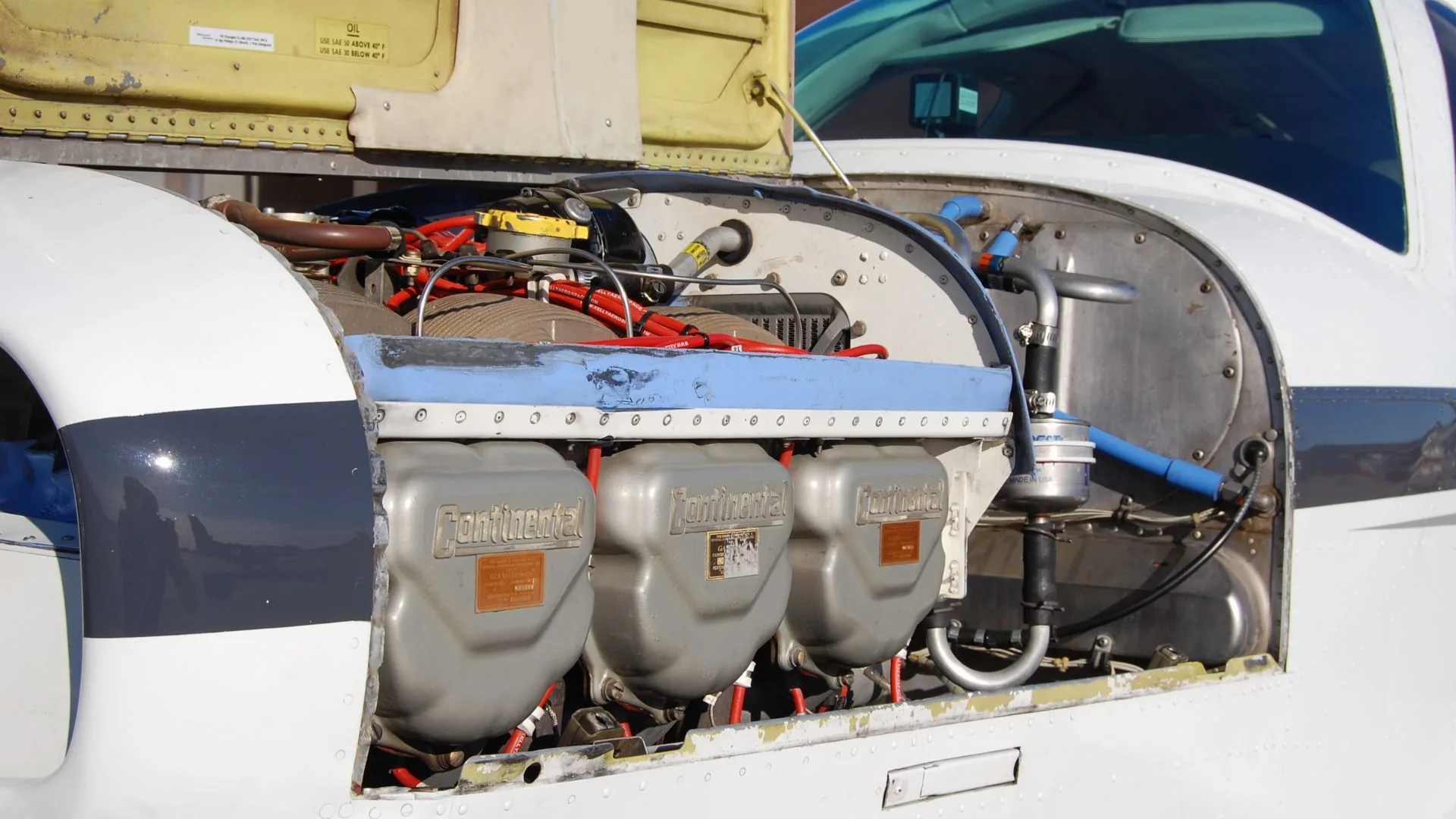 Close-up of the engine of a Beechcraft Bonanza with the cowling removed.