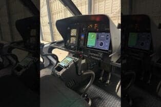 The helicopter's cockpit features modern avionics and displays.