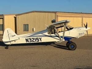 N321SY is a white and blue CubCrafters XCub parked on the tarmac.