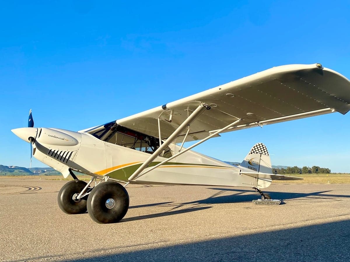 A Carbon Cub FX-3 aircraft with tail number N363SS is parked on the tarmac.