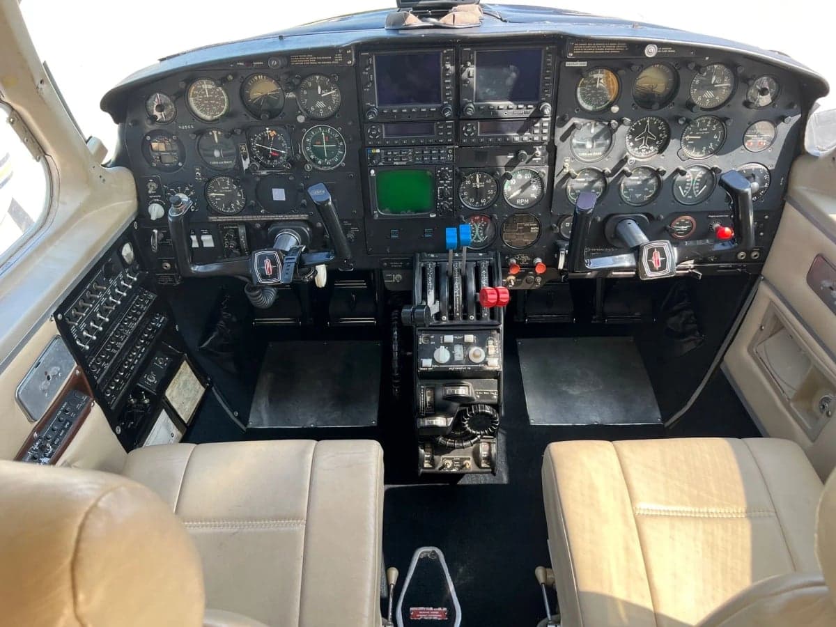 Interior view of the aircraft cabin showing the rear seats and luggage.