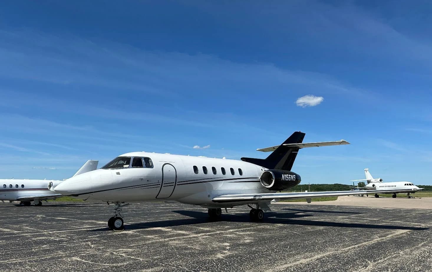 Hawker 400XP, registration N156NS, parked on the tarmac.