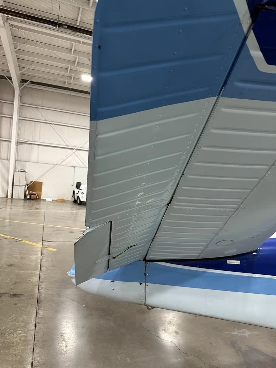 A close-up view of the blue and white V-tail of the Beechcraft Bonanza N9936R.