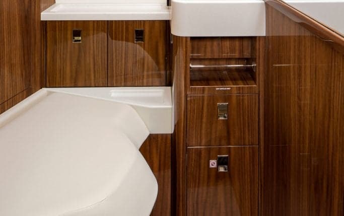 A single leather seat is positioned next to a window in the aircraft's cabin.