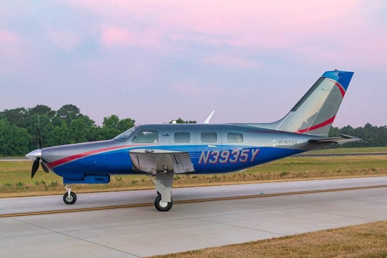 Piper Mirage N3935Y on the runway, side view.