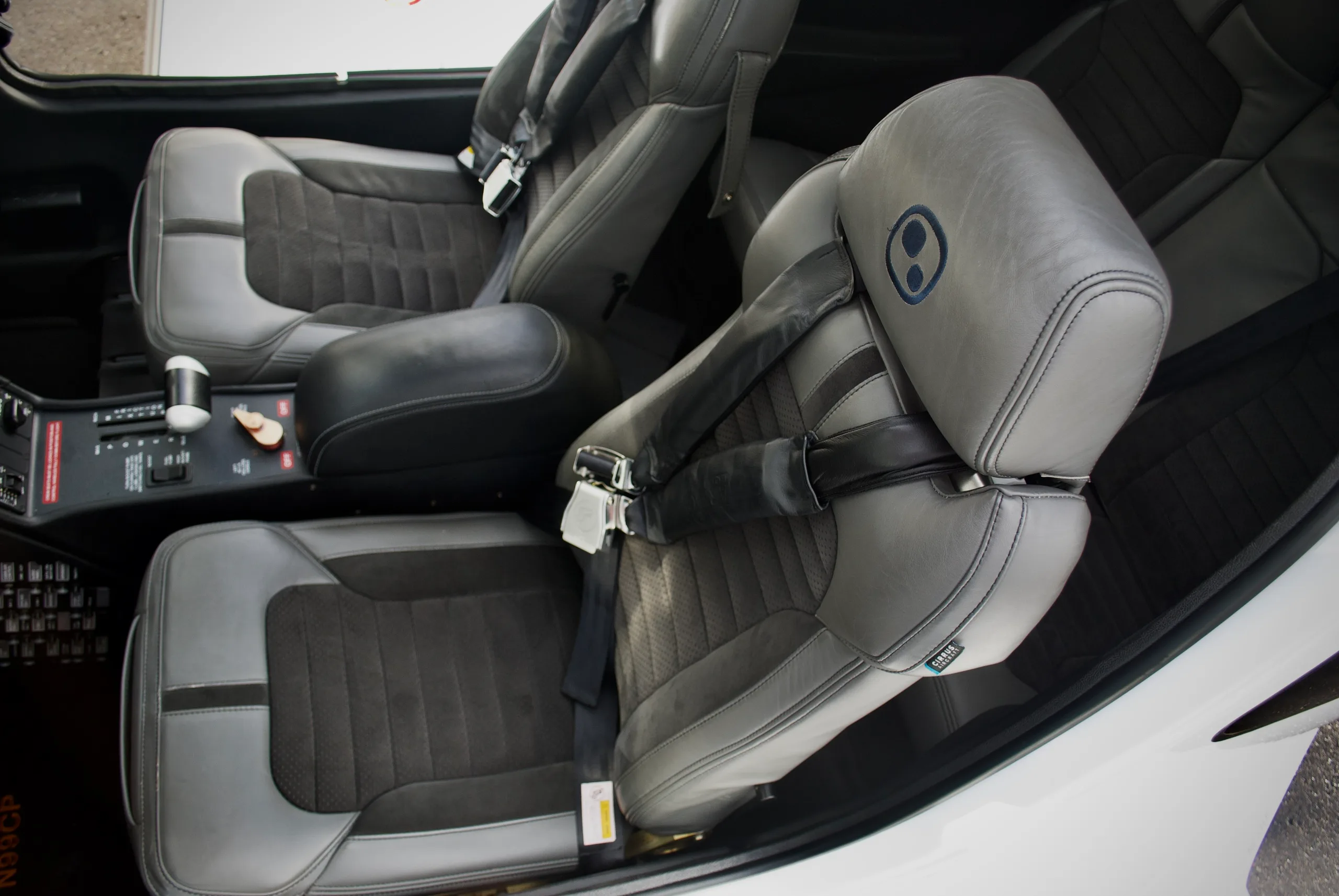An overhead view of the gray and black leather interior seats of the Cirrus SR22T aircraft.