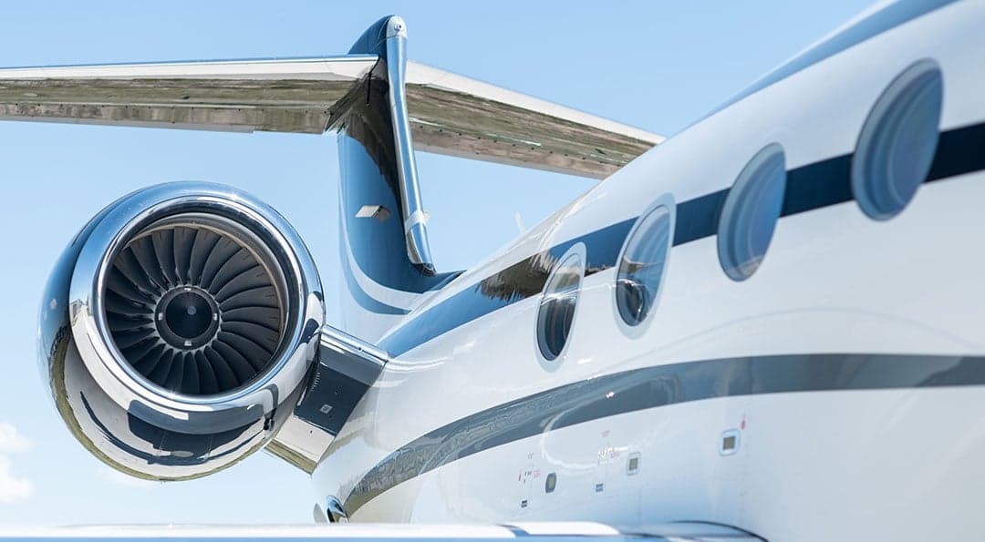 Close-up of the tail, engine, and fuselage windows of the Gulfstream G550 aircraft.