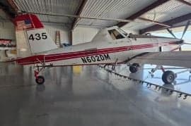 Cropduster aircraft in a hangar with red and white paint scheme.