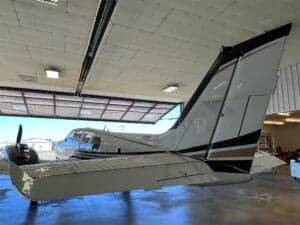 Tail section of N728HS aircraft inside a hangar.