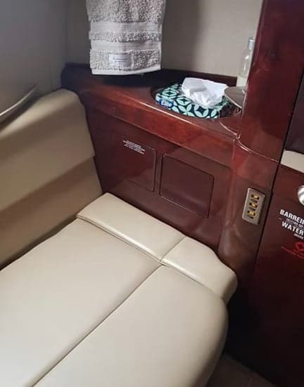 A small section of the aircraft cabin with a seat and storage area.
