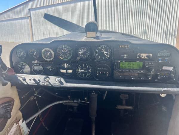 A wide view of the aircraft's cockpit, showing the complete instrument panel, controls, and floor area with registration N5039G.