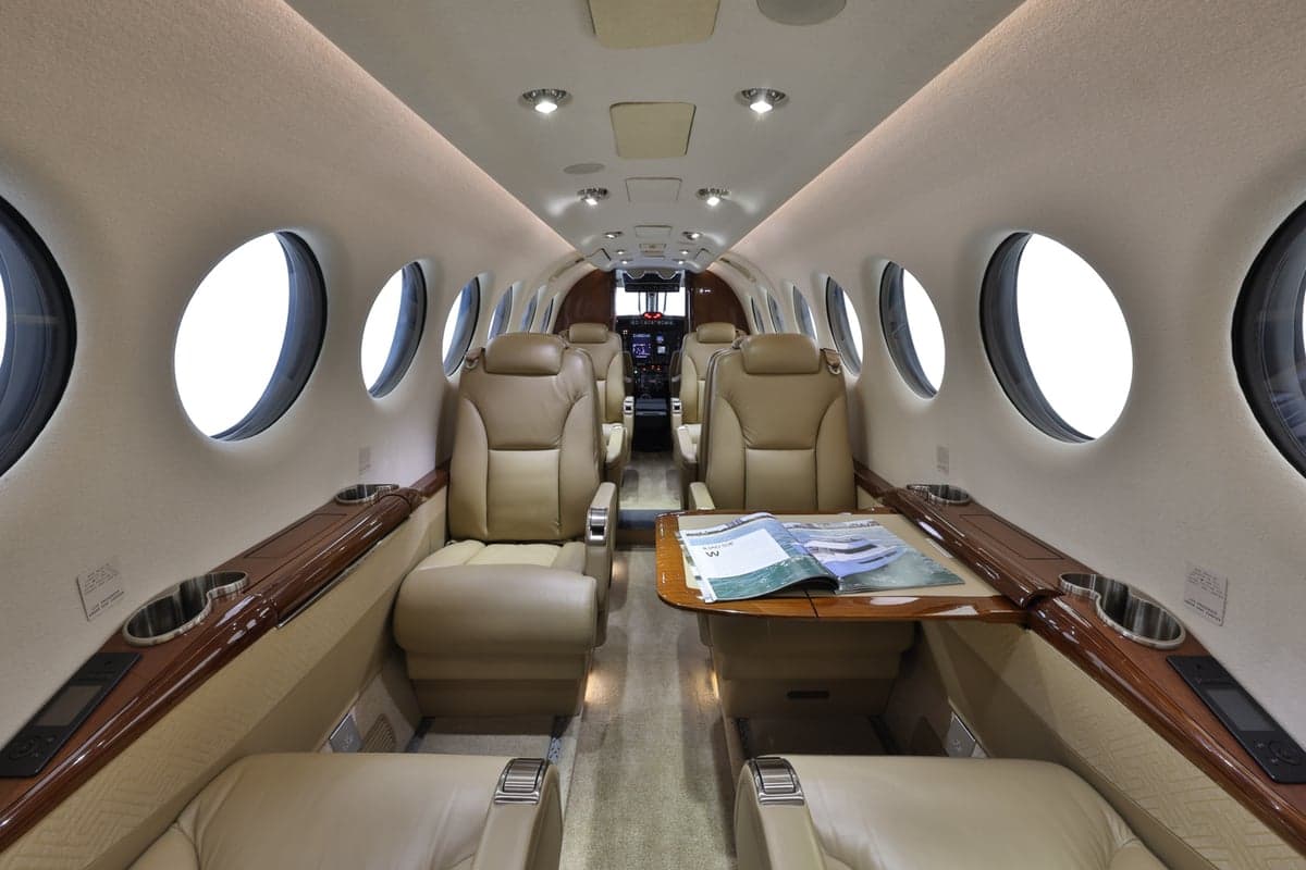 Full view of the King Air 350 cabin interior with leather seats and table.
