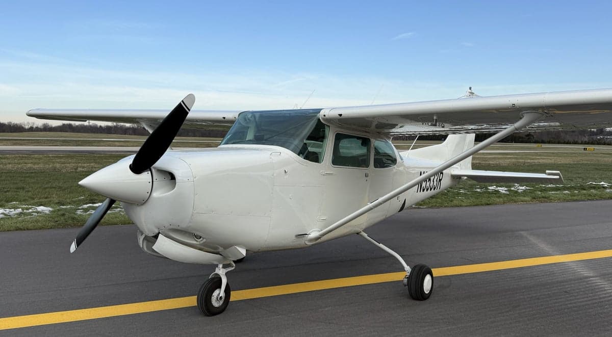 Front quarter view of a Cessna 172 aircraft with tail number N5533R parked on the tarmac.
