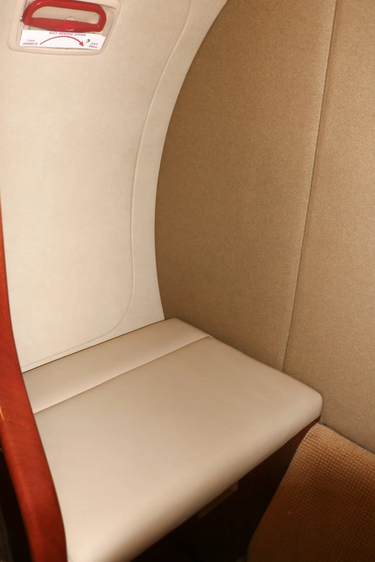 Close-up of a Citation CJ2 cabin seat and emergency exit instructions.