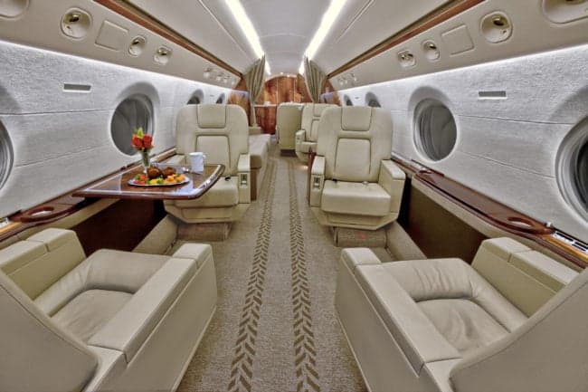A view of the aircraft's interior, featuring comfortable seating and a table.