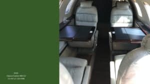 Interior of the Cessna Citation 525 CJ1 with executive seating and a diagram of the layout.