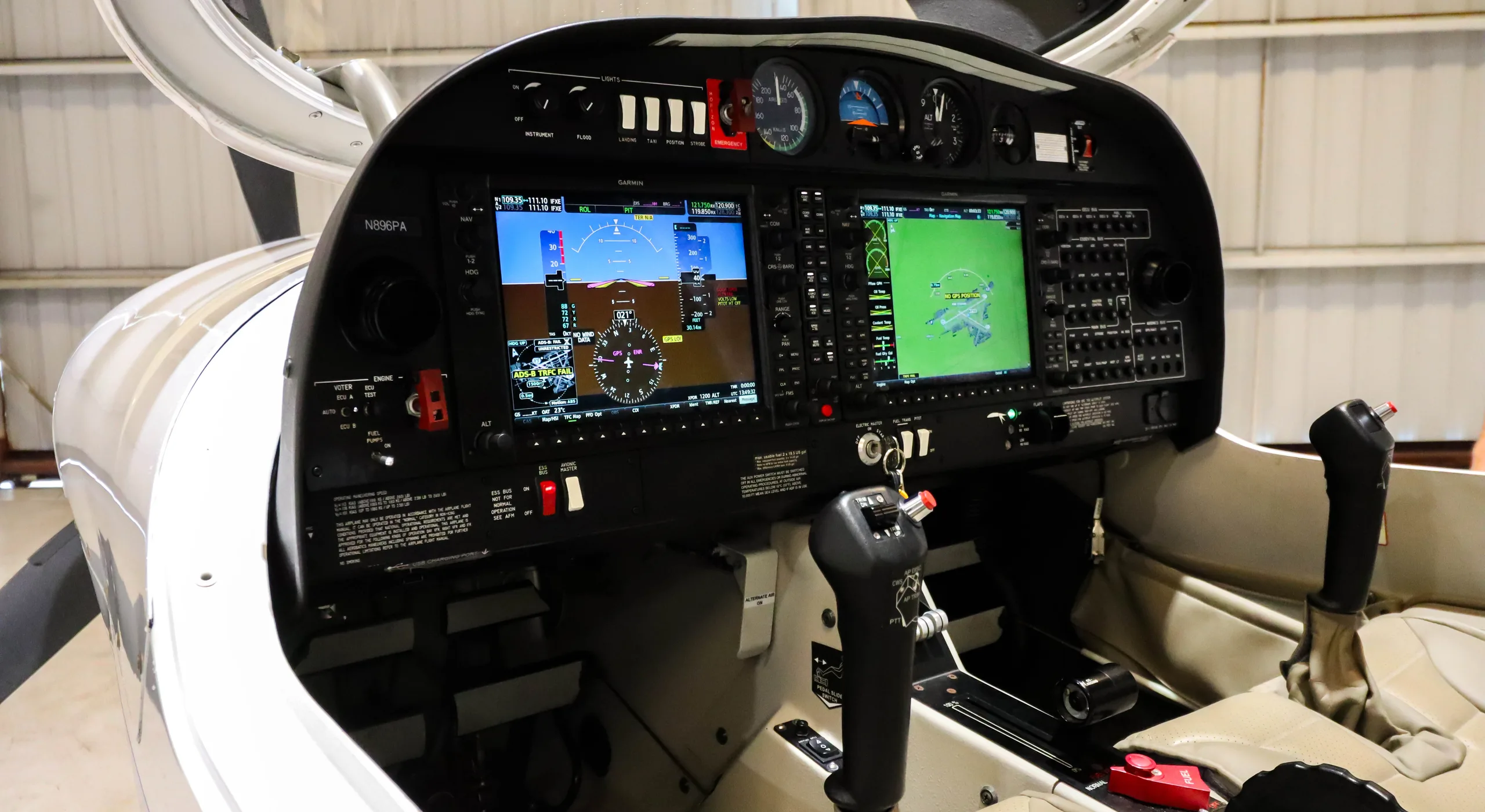 An angled view of the Diamond DA40 cockpit, highlighting the instrument panel with digital screens and side stick controls.