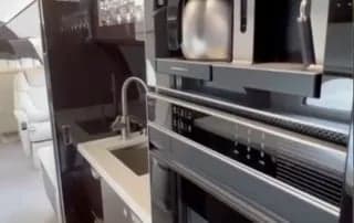 Close up of the galley area with sink and appliances.