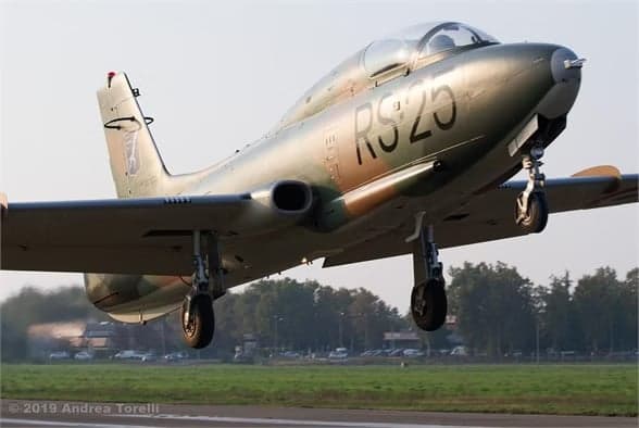 Camouflaged aircraft I-MBCK landing on a runway.