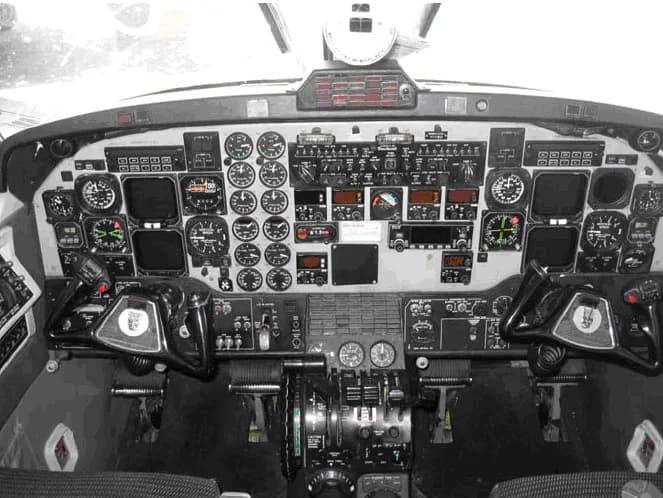 A black and white photo of an aircraft cockpit instrument panel.