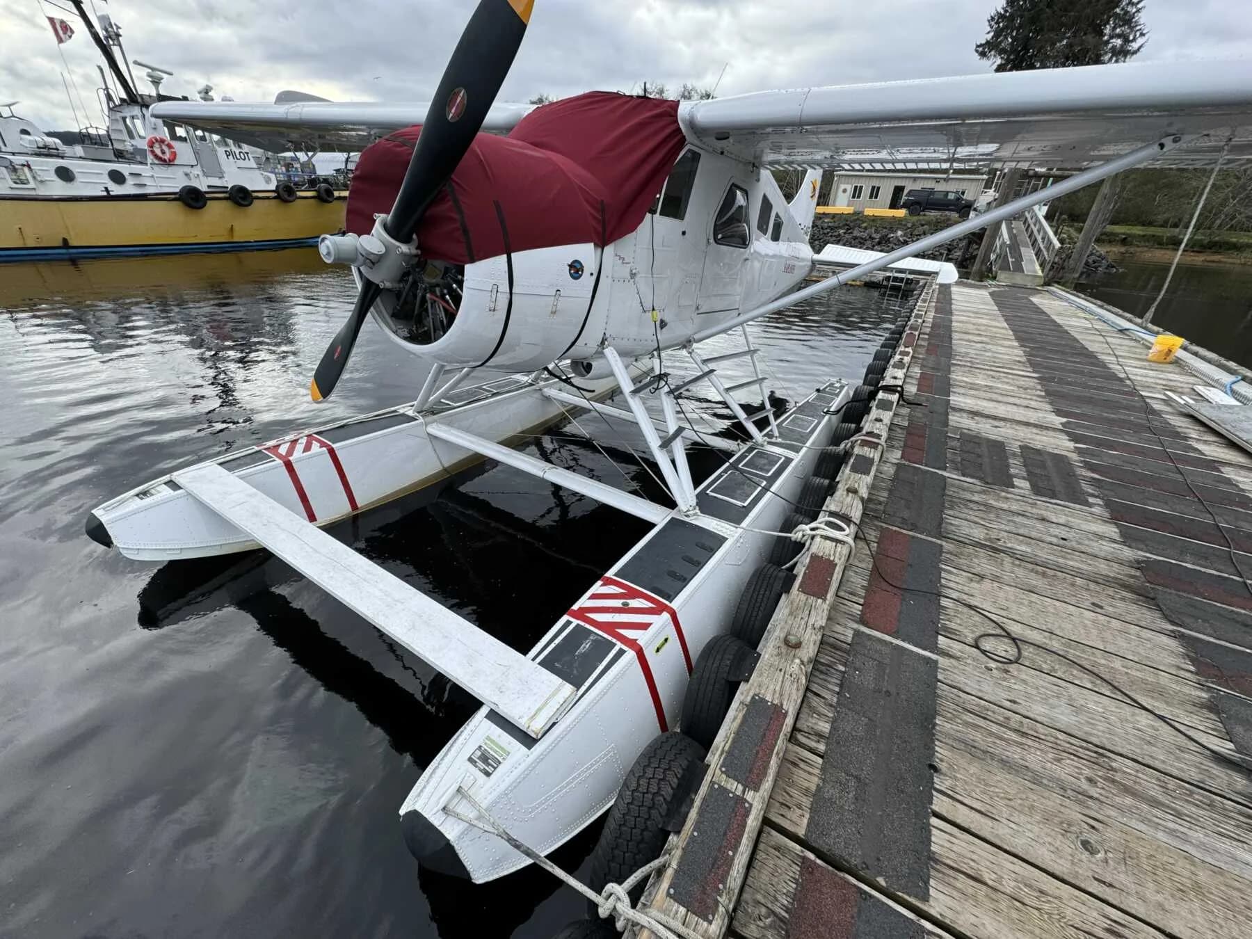 Front view of a de Havilland Beaver floatplane on a dock.
