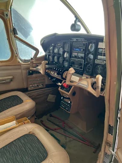 View of the aircraft cockpit instrument panel and seats.