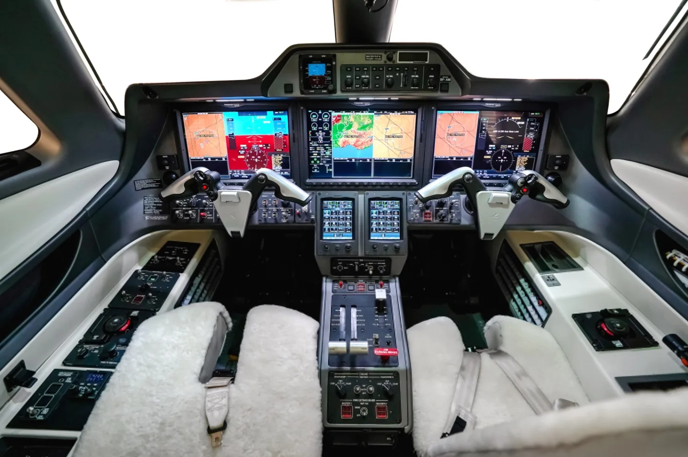 The Phenom 300E cockpit features a modern glass panel display and controls.