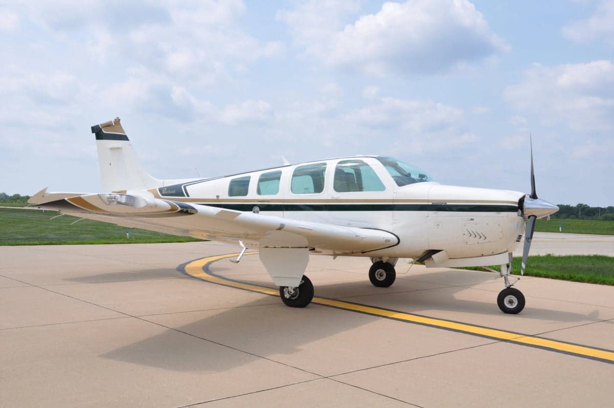 A Beechcraft Bonanza aircraft parked on the tarmac.