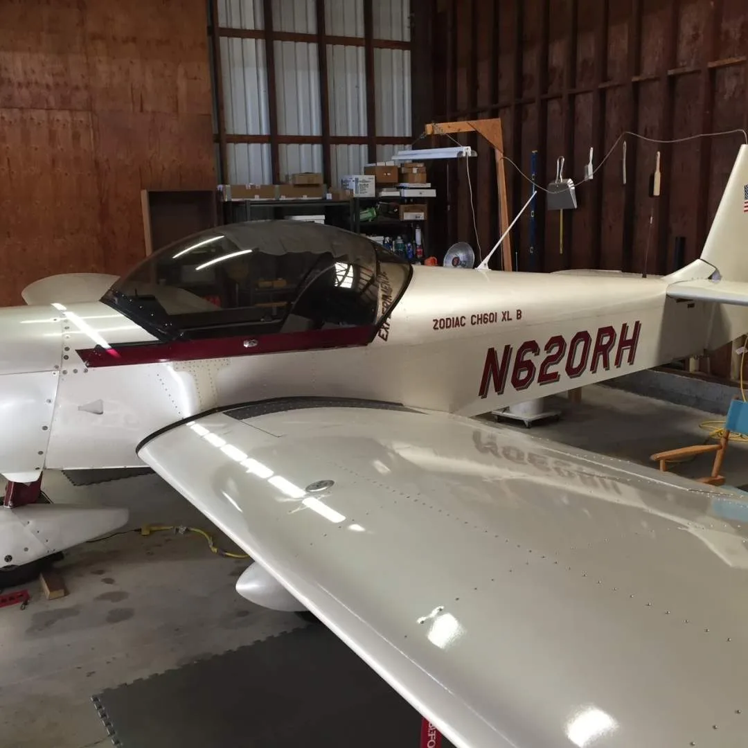 A detailed side view of the Zodiac CH601 XL B aircraft, highlighting the cockpit canopy and wing.